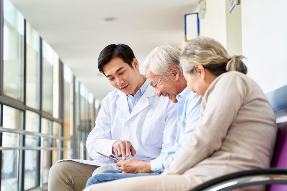 doctor discussing medicare plan with elderly couple